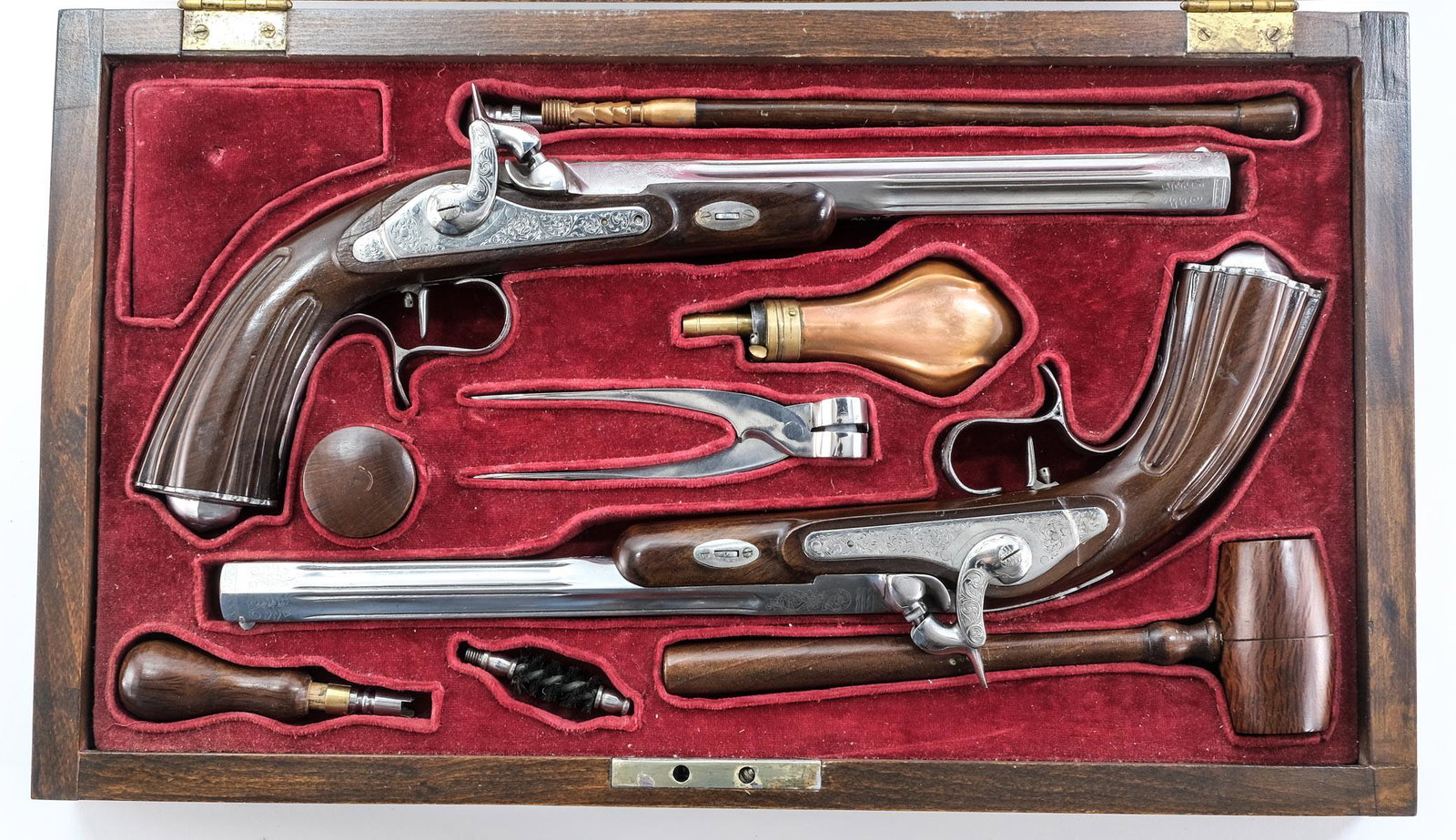 Pair of Cased Reproduction Dueling Pistols: Description In the Belgian or French 19th Century Style. .41 Caliber Percussion Pistol set. Unmarked except for vibrapen inscribed Serial numbers under the bbls. Each with 9" barrels, engraved through