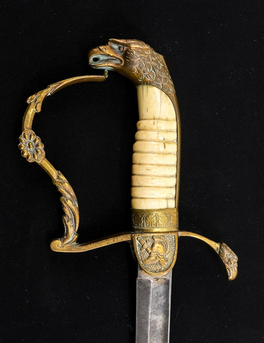 US War of 1812 Era Officers Dress Sword: Description Gilt Brass Eagle Head Pommel and crossguard with foliate designs. Bone grip, 31.5" straight blade: engraved, 1/3 Blued, unmarked. with an unmarked matching brass scabbard. Condition: exhib