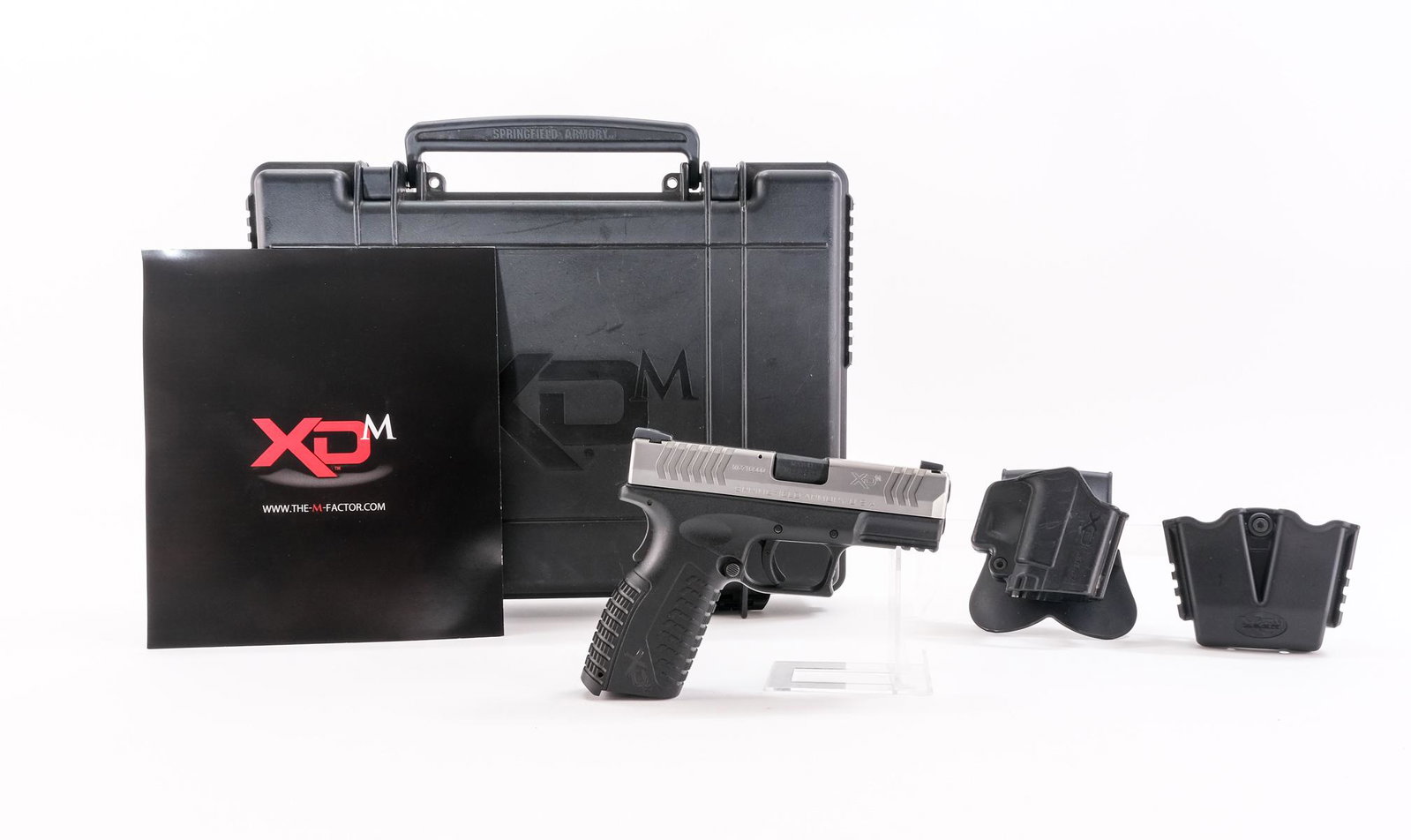 Springfield Arms XDM 9mm Semi-Auto Pistol: Description Springfield Arms model XDM-9 in .9mm missing its magazine with a 3 3/4" barrel. Composite frame and trigger. Metal slide and barrel. Ambidextrous magazine release button on the grip. Grip 
