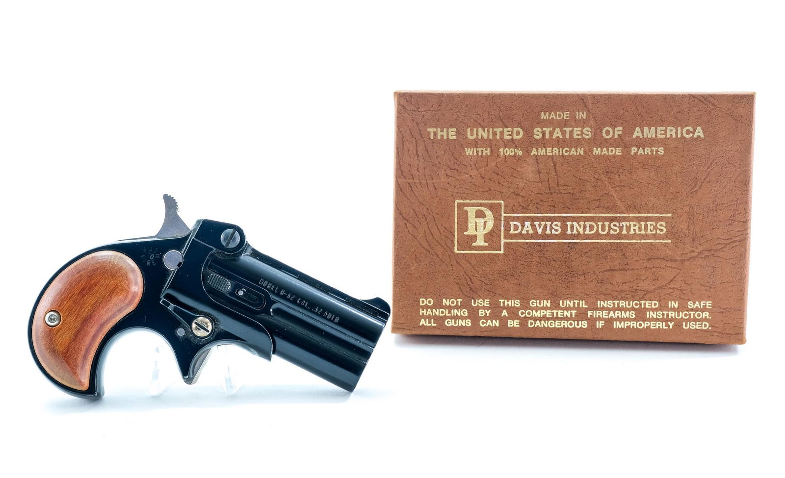 Davis D-32 .32 Auto Derringer Pistol: Description Davis Industries model D-32 in .32 Auto with a two shot capacity and a 2 3/8" barrel. Solid wooden grip plates. Black frame and barrels. Steel hammer, trigger and cross hammer safety butto