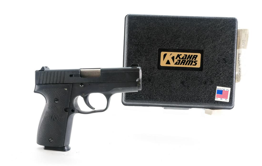 Kahr K9 9mm Semi-Auto Pistol: Description Kahr model K9 in 9mm with (1) seven round removable magazine and a 4" barrel. Dimpled rubber Kahr grip plates. Black finished metal frame, smooth trigger and serrated slide. Left side of f