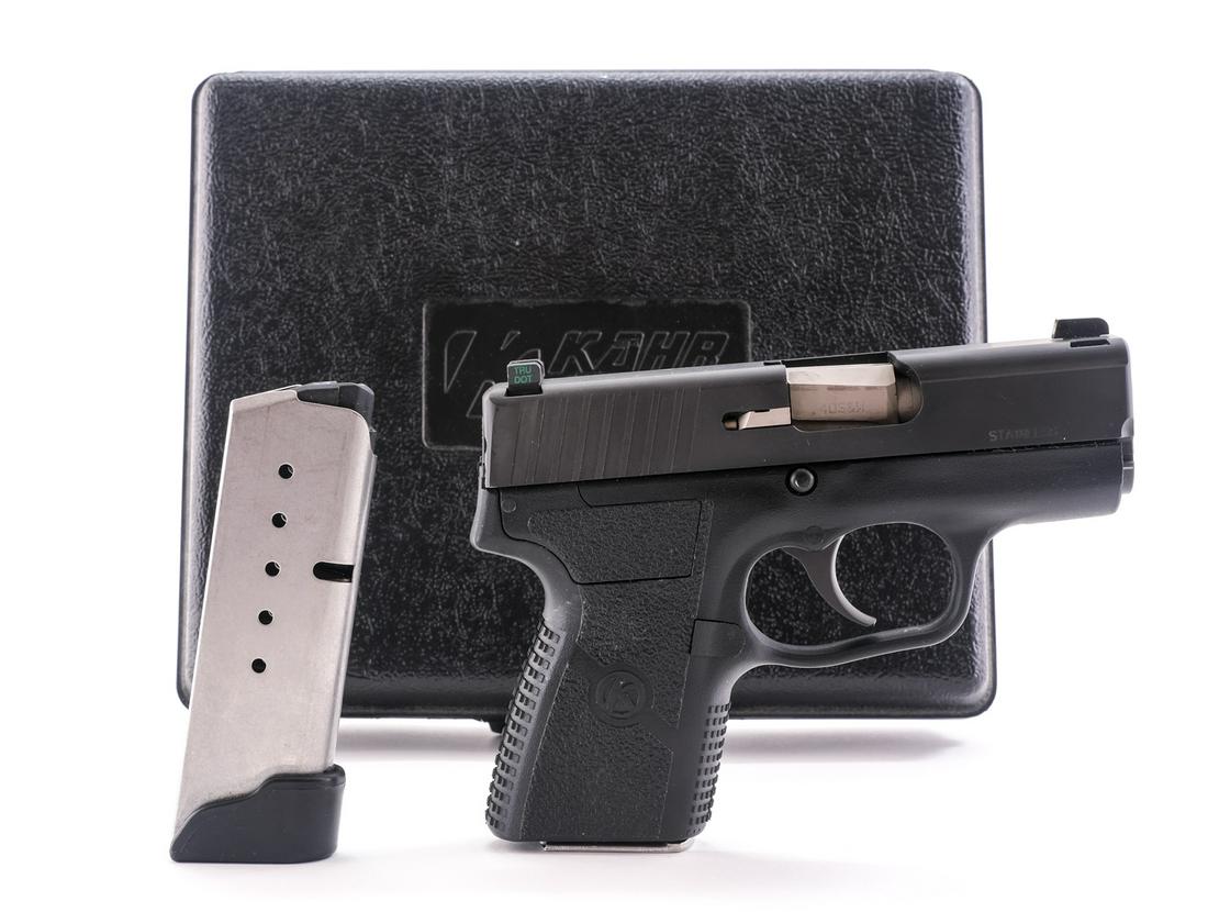 Kahr PM40 .40 S&W Semi-Auto Pistol: Description Kahr model PM40 in .40 S&W with two, six round removable magazines and a 3" barrel. Polymer frame with blued serrated stainless steel slide. "TRU DOT" iron sights. Left side of frame serra