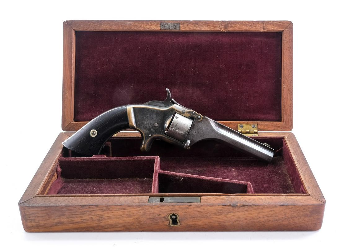 S&W #1 .22 Short Revolver: Description Smith & Wesson model 1 in .22 short Black Powder cartridges with a seven round capacity and a 3.5" barrel. Solid smooth wood grip plates. Plated brass frame. Unfluted steel cylinder. Octag
