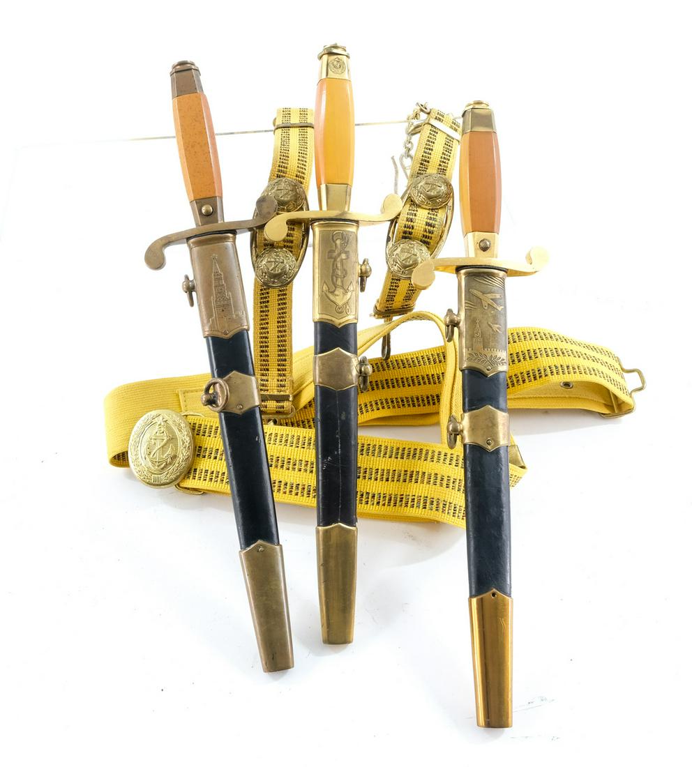 Soviet Russian Military Daggers: Description Includes a post-war Air Force Dagger (w/ button) with Balde marked "3NK 57", a KGB or Kremlin Guard Dagger (w/ button) Blade marked "3 NK 57" and a WWII Era Buttonless Navy Dagger marked 3