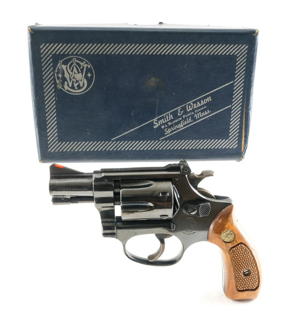 Smith & Wesson 34-1 .22 LR. Revolver: Description Smith & Wesson Model 34-1 in .22 long rifle with a six round cylinder capacity with a 2" barrel. S&W checkered wood grip plates. Blued frame, cylinder and barrel. Case colored checkered ha