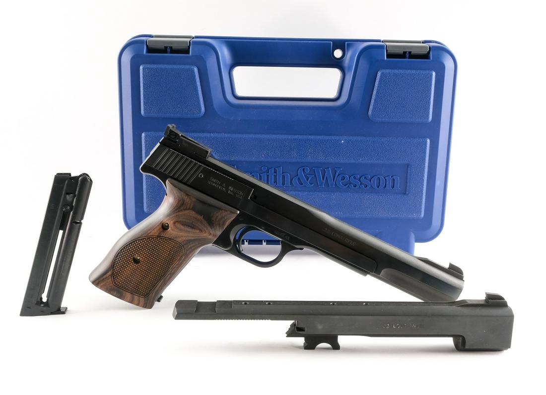 S&W 41 .22 LR Semi-Auto Pistol: Description Smith & Wesson Model 41 in .22 LR with two, ten round removable magazines and a 7" barrel. S&W checkered walnut grips with thumb rest. Blued frame, serrated slide and serrated trigger. Adj