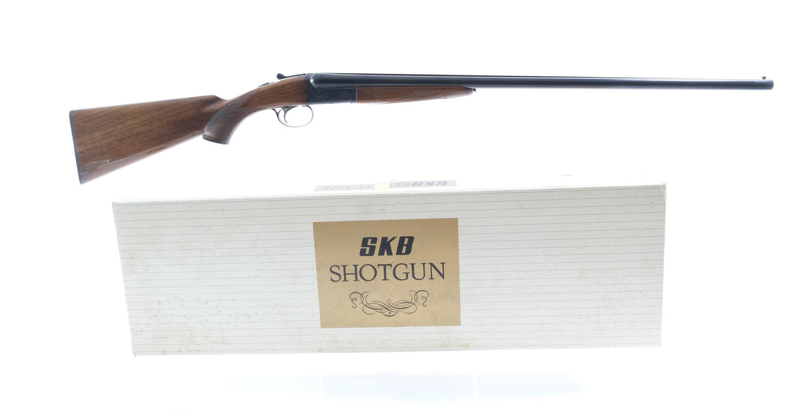 SKB Arms 100 20Ga SxS Shotgun: Description SKB Arms Model 100 in 20 ga and a 28" top checkered rib barrel. The right barrel has a MOD fixed choke and the Left has a FULL fixed. Black checkered composite butt plate. Checkered wood s