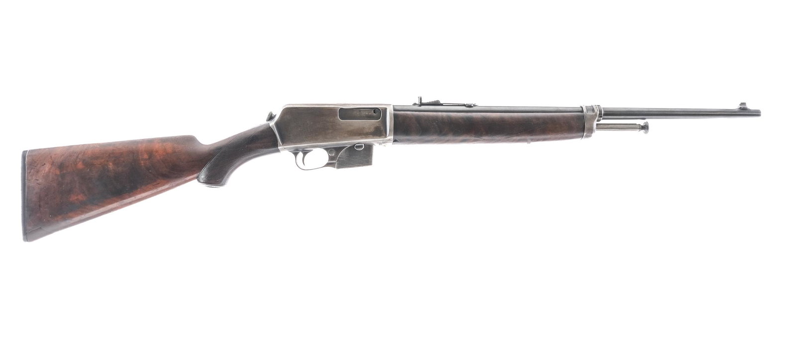 Winchester 1907 .351 WSL Semi Auto Rifle: Description Winchester model 1907 chambered in .351 Winchester self loading with one, five round removable magazine and a 20" blued barrel. Blowback rifle with front cocking plunger. Textured wood for