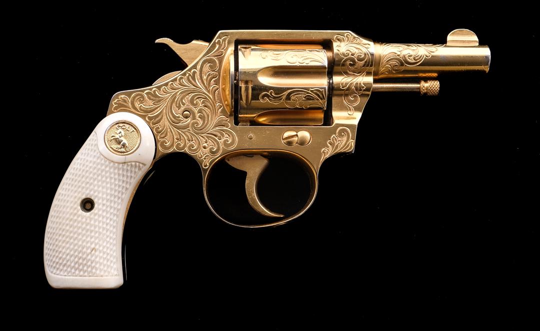 Colt Pocket Positive .32 Police DA Revolver: Description Colt Pocket Positive in .32 Police with a six round capacity and a 2.5" barrel. Checkered Colt bone/antler grip plates. After Market gold finished engraved frame, cylinder and barrel. Gold