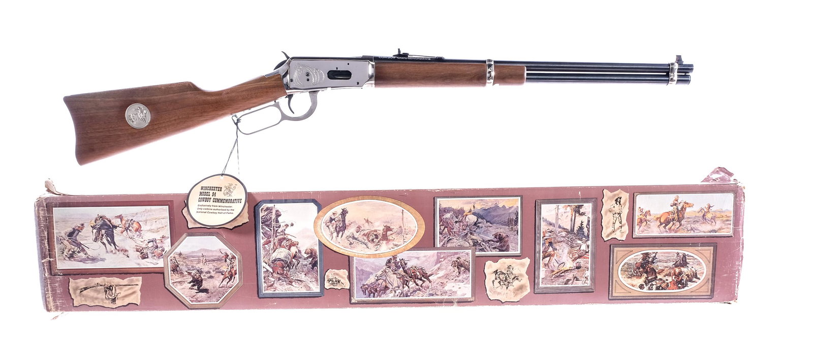 Winchester Cowboy Commemorative .30-30 Rifle: Description Winchester Cowboy Commemorative in .30-30 Springfield with a seven round capacity and a 20" barrel. Nickel finished butt plate. Smooth wood stock and front foregrip. Nickel finished hand l