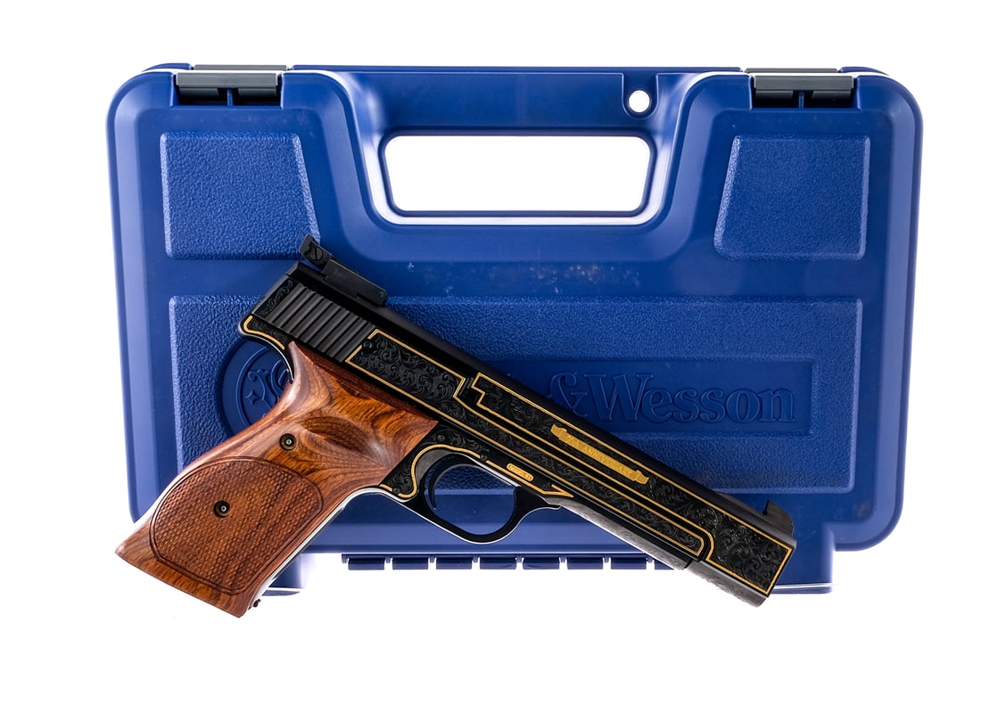 S&W 41 50th Anniversary .22LR Semi Auto Pistol: Description Smith & Wesson Model 41 50th Anniversary Gold Leaf Edition chambered in .22 long rifle with two, ten round removable magazines and a 5.5" engraved slab sided barrel. Engraved blued steel f