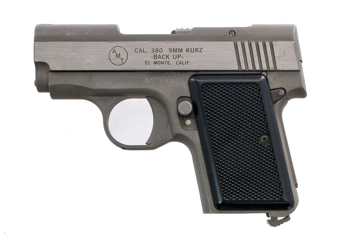AMT Backup .380 Semi Auto Pistol: Description AMT Backup in .380 ACP with a 2.5" barrel. Black plastic grip plates. Matte stainless steel frame, solid trigger and serrated slide. Left side of frame safety switch. Serrated heel magazin