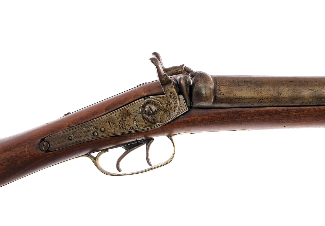 Goulcher SxS 12Ga BP Shotgun: Description G. Goulcher in 12 gauge bore with a two round capacity and a side by side 31" top rib barrel. Metal butt plate. Smooth wood stock. Brass trigger guard. Finish worn double triggers, lock pl