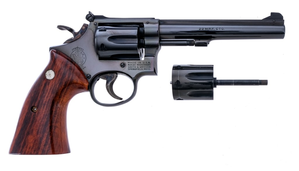 S&W 48 No Dash .22 Mag Revolver +.22LR Cylinder: Description Smith & Wesson model 48 No Dash chambered in .22 magnum with six-shot cylinder and a 6" barrel. Manufactured in 1973 with serial number 5K71484. Blued barrel, frame, fluted cylinder, and c