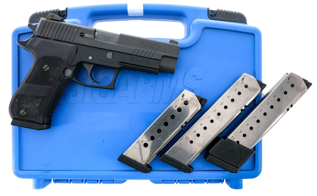 Sig Sauer P220 Elite .45 ACP Semi Auto Pistol: Description Sig Sauer P220 Elite chambered in .45 ACP with four magazines and a 4.4" barrel. Black finished alloy frame with checkered polymer wrap around grips. Front picatinny accessories rail. Doub