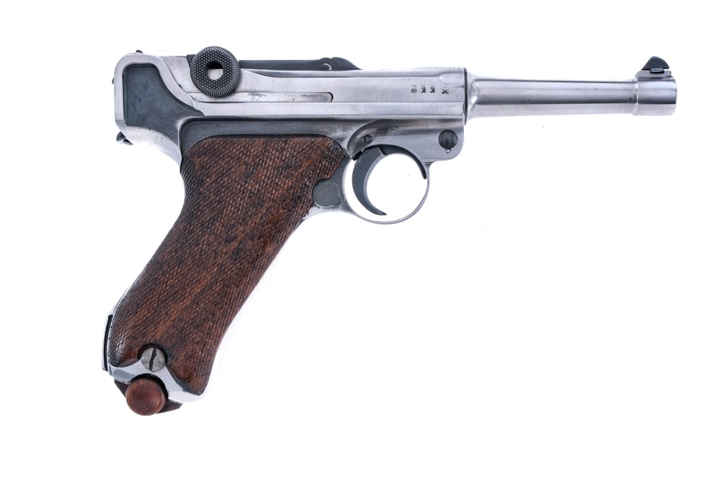 DWM 1914 Military Luger 9mm (1916) Pistol: Description DWM 1914 Military P08 Luger chambered in 9mm with one, eight round magazine with wood base plate, and a 4" barrel. Manufactured in 1916 with serial number 2775h. Steel frame with stock lug