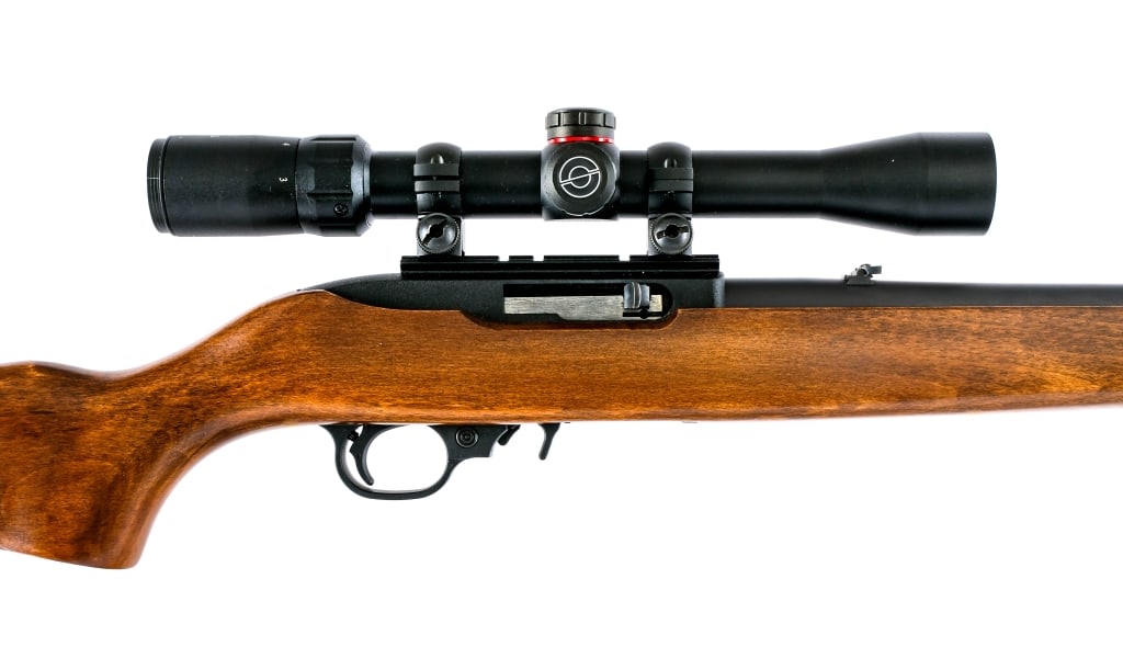 Ruger 10/22 Carbine .22 LR Semi Auto Rifle: Description Ruger 10/22 Carbine in .22 Long Rifle with one, ten round removable magazine and a 18.5" barrel. Made in Newport New Hampshire in 2010. Black composite butt plate. Smooth wood stock. Black