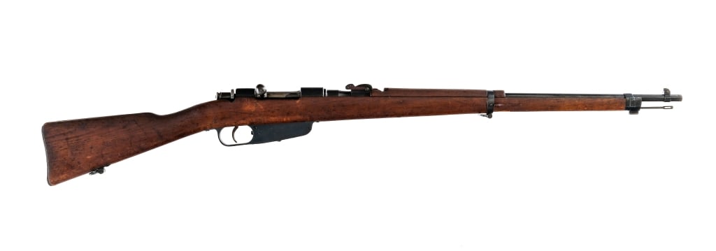 Terni Carcano M91/42 6.5x52mm Bolt Action Rifle: Description Terni Carcano Model 91/42 in 6.5x52mm with a five round capacity and a 27" barrel. Blued metal butt plate. Smooth wood stock and front forend. Blued trigger guard, receiver and barrel. Unf