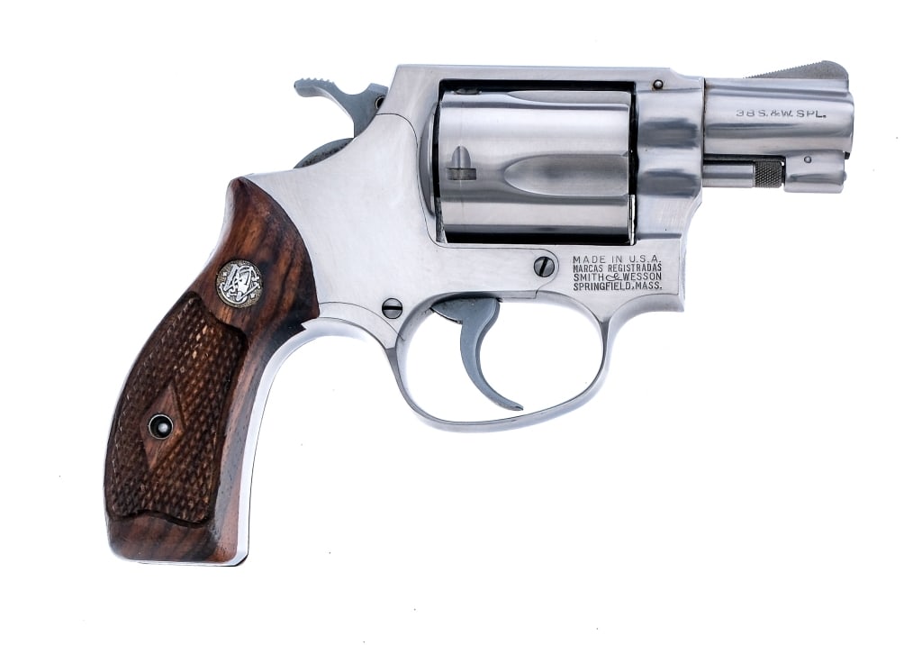 Smith & Wesson 60 .38 Special Revolver: Description Smith & Wesson model 60 chambered in .38 special with a five-shot cylinder and a 1.875" snub nose barrel. Serial number 491255. Stainless steel barrel, frame, fluted cylinder, checkered cy