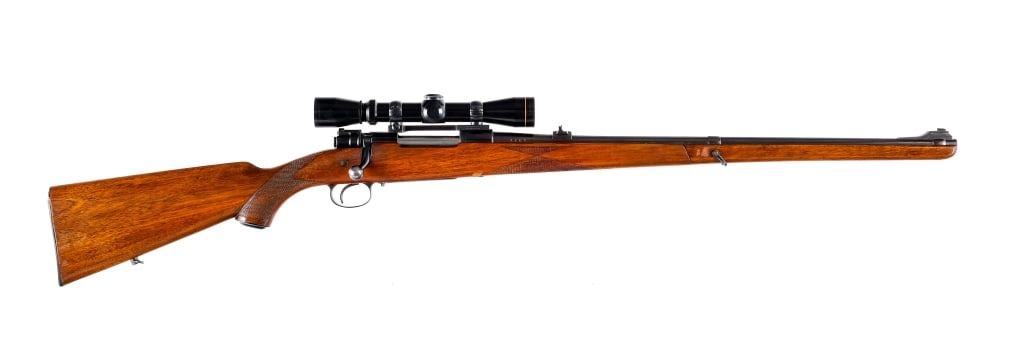 H. Dumoulin Mauser Type 7x57 Bolt Rifle: H. Dumoulin Mauser Type Rifle in 7x57mm with a five round capacity and a 24" barrel. Checkered wood stock and full length two piece front forend. Blued receiver and barrel. Rear bolt flag safety. Mid 