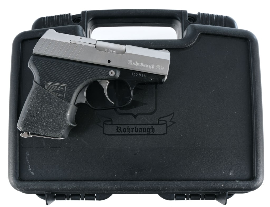 Rohrbaugh R9 9mm Semi Auto Pistol: Rohrbaugh R9 chambered in 9mm with one, six round magazine and a 2.9" barrel. Black finished alloy frame with textured polymer grip panels and aftermarket grip sleeve. Heel magazine release. Double ac