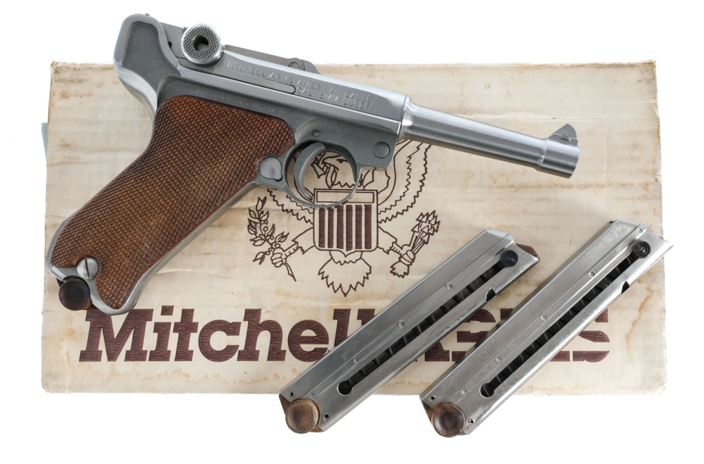 Mitchell Arms American Eagle Luger 9mm Pistol: Mitchell Arms American Eagle P08 Luger chambered in 9mm with three magazines and a 4" barrel. Manufactured in 1992, marked on the top of the upper. Stainless steel finish with checkered wood grips. Fr