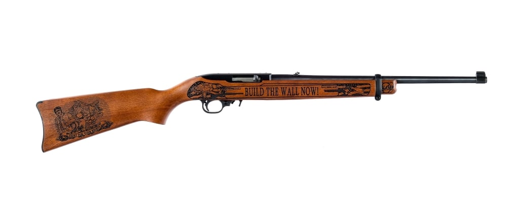 Ruger 10/22 Build The Wall .22 LR Rifle: Ruger 10/22 Trump Build The Wall chambered in .22 Long Rifle with three, ten round rotary magazines and an 18.5" barrel. Manufactured in 2019. Number 2 of only 45 manufactured. Adjustable rear sight a