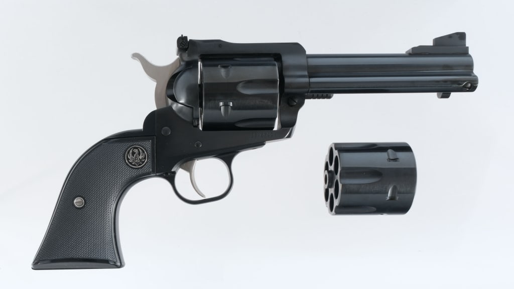 Ruger New Model Blackhawk .45 Colt/ACP Revolver: Ruger New Model Blackhawk chambered in .45 Colt/ACP with six-shot cylinders and a 4.5" barrels. Manufactured in 2017 with serial number 38-68491. Blued barrel, frame, and fluted cylinders. Stainless s