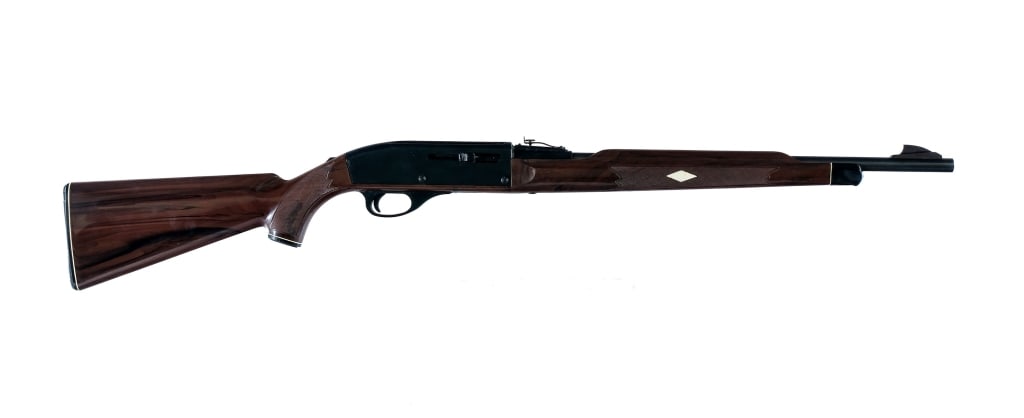 Remington Nylon 66 .22 LR Semi Auto Rifle: Remington Nylon 66 (Mohawk Brown) in .22 Long Rifle with a fourteen round capacity and a 19.5" barrel. Made in 1972. Serrated black composite butt plate with magazine tube hand knob. Checkered brown c