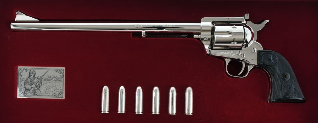 Colt Ned Buntline Commemorative .45 LC Revolver: Colt New Frontier Ned Buntline Commemorative in .45 Long Colt with a six round capacity and a 12" barrel. This revolver is one of only 3,000 made in 1979. Checkered composite grip plates. Nickel finis