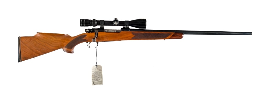 Unknown .264 Win Mag Custom Bolt Action Rifle: Description Unknown/Unmarked maker in .264 Winchester Magnum with a four round capacity and a 24.5" barrel. Checkered Monte Carlo style wood stock and front forend. Engraved trigger guard and magazine