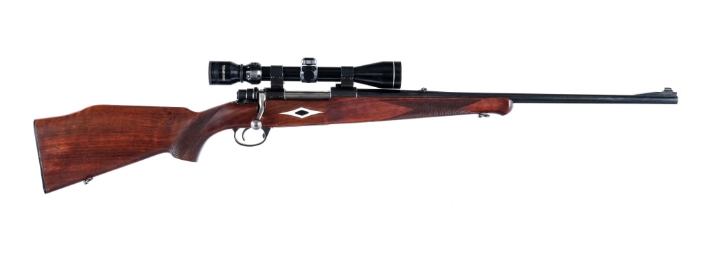 Tradewinds Husky H-5000 .243 Win Bolt Rifle: Description Tradewinds Husky Model H-5000 in .243 Winchester with a five round capacity and a 22.5" barrel. Checkered wood stock with composite diamond inlays. Blued receiver and barrel. Rear receiver