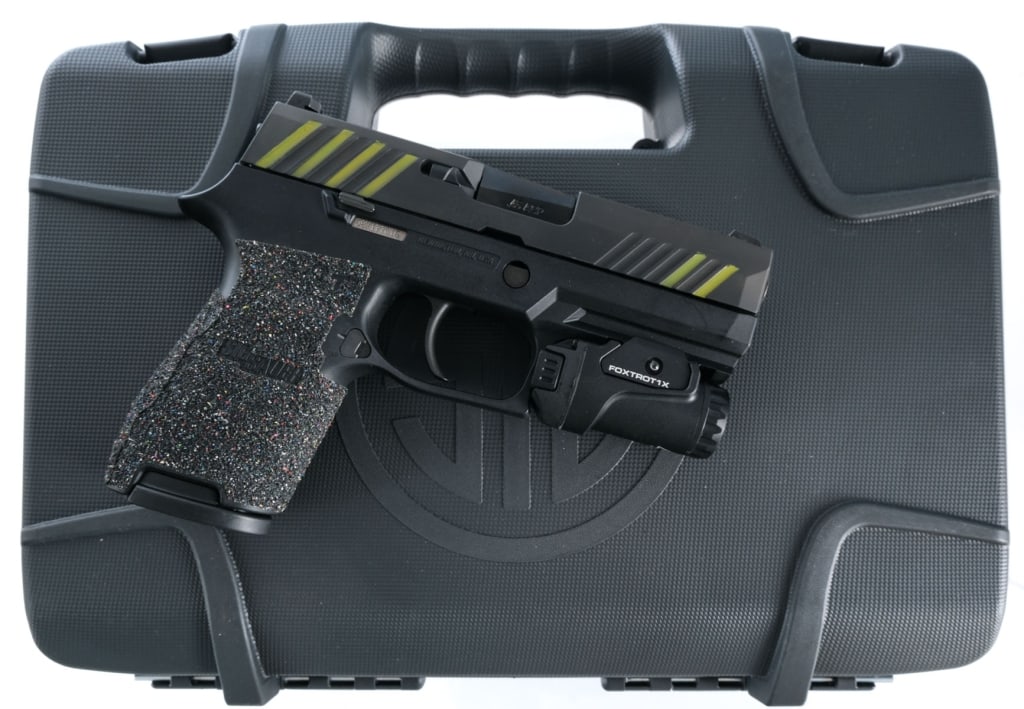 Sig Sauer P320C .45 ACP Semi Auto Pistol: Description Sig Sauer P320C chambered in .45 ACP with one, nine round magazine and a 3.9" barrel. Textured polymer frame with accessories rail and aftermarket grip tape. Mounted Sig Foxtrot flash ligh