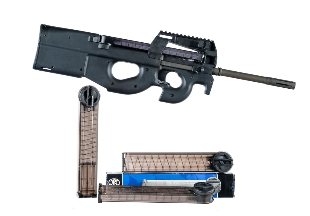 FN PS90 5.7X28mm Semi Auto Bullpup Rifle: Description FN PS90 chambered in 5.7x28mm with four, fifty round translucent magazines and a 16" chrome lined barrel with built in ported muzzle break. Synthetic thumbhole bullpup stock with forward h