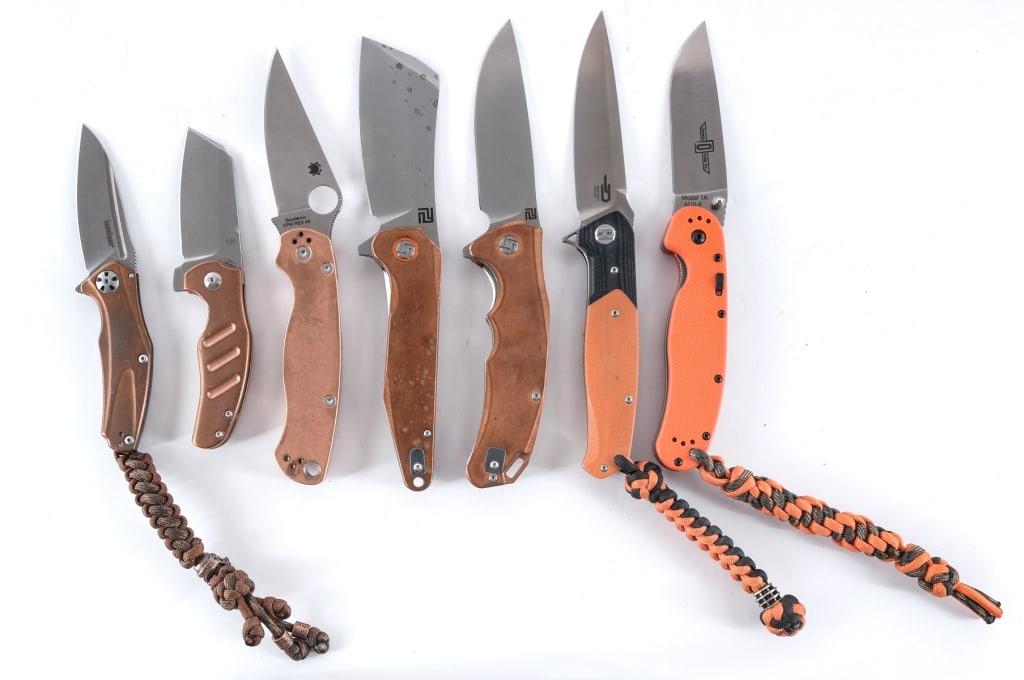 Folding Pocket Knives 7 Pcs Lot Knife: Description This lot is for seven folding knives from various makers. Ontario Knife Co Model 1A AUS-8 with a 3.75" blade and orange composite grip plates. Comes with paracord lanyard. Blade marked Gre