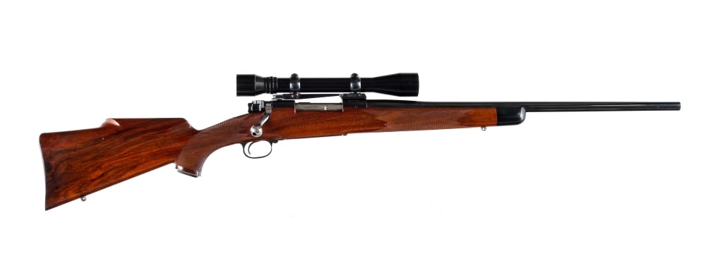 Winchester 70 Bolt Action Rifle: Description Winchester 70 in an unknown/unmarked caliber with a four round capacity and a 22" barrel. Made in New Haven Connecticut in 1954. Checkered blued butt plate. Checkered Monte Caro style wood