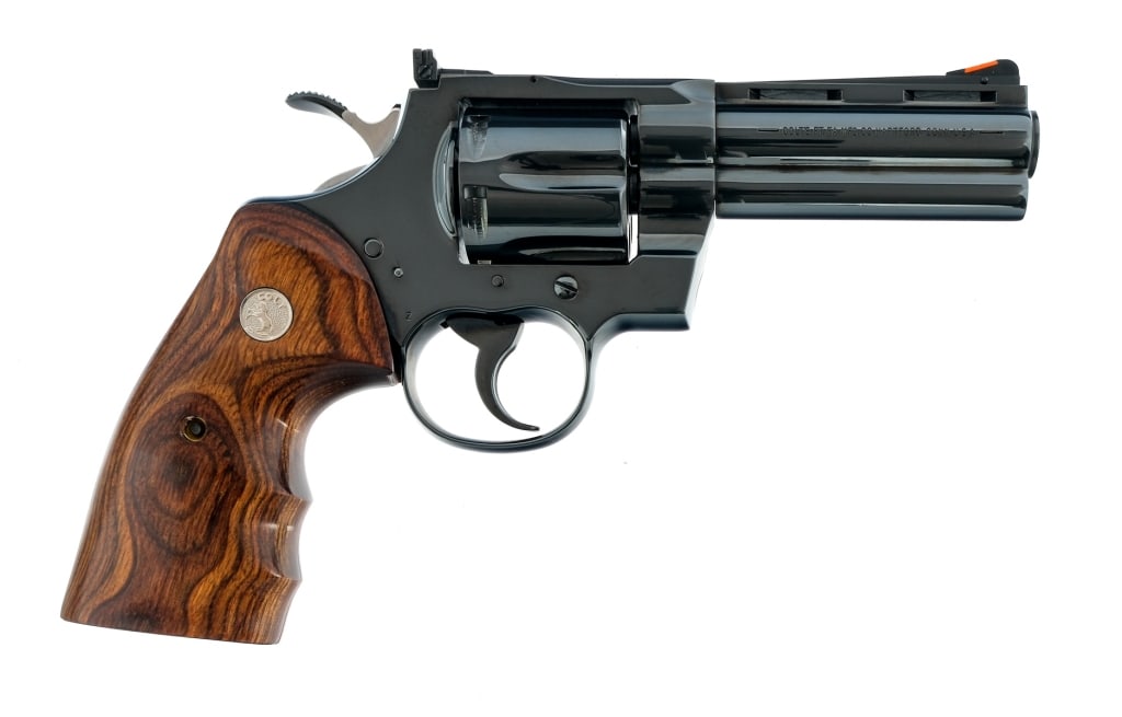 Colt Python .357 Magnum Revolver: Description Colt Python in .357 Magnum with a six round capacity and a 4" vented rib barrel. Made in Hartford Connecticut in 2000. Laminated wood grip plates with Rampant Colt medallions on each side.