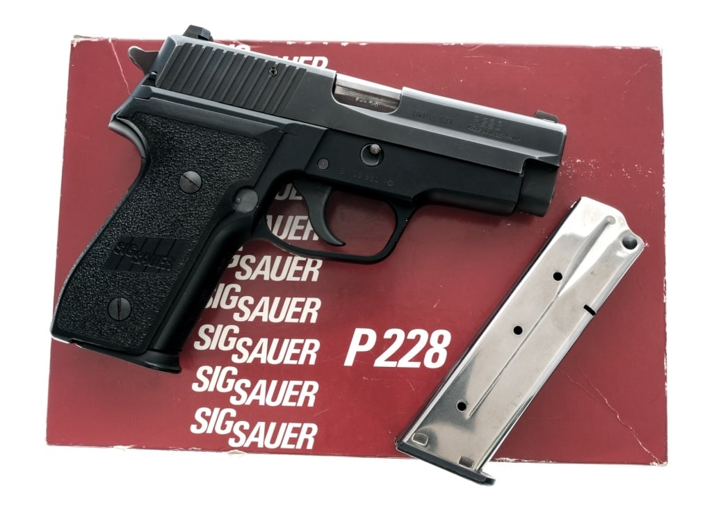 German Sig Sauer P228 9mm Semi Auto Pistol: Description Sig Sauer P228 chambered in 9mm with two, thirteen round magazines and a 3.9" barrel. Manufactured in Germany in 1989 with JK date code. Black finished alloy frame with checkered polymer g
