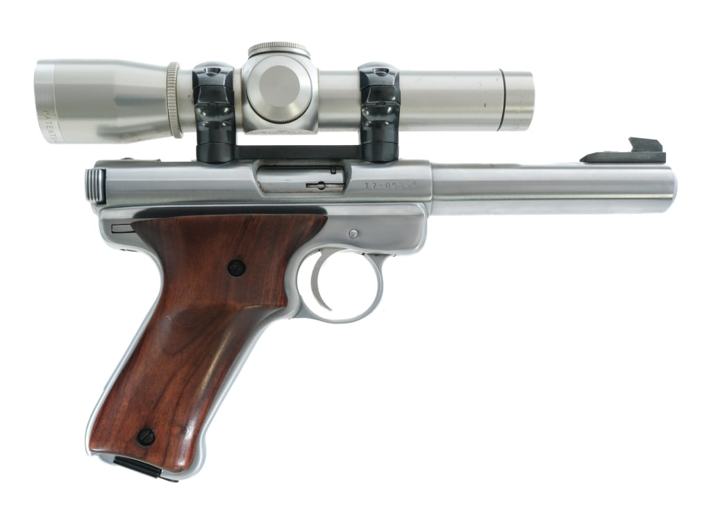 Ruger Mark I .22 LR Semi Auto Pistol: Description Ruger Mark I chambered in .22 long rifle with one magazine and a 5.5" bull barrel. Stainless steel frame with smooth wood grips. Heel magazine release. Frame mounted thumb safety. Stainles