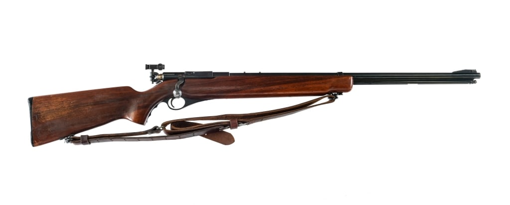 O.F. Mossberg & Sons 46B-B .22 Bolt Action Rifle: Description O.F. Mossberg & Sons model 46 B-B in .22 short and long rifle with a 26" barrel. Serrated composite butt plate. Monte Carlo style wood stock. Case colored trigger and bolt handle. Blued re