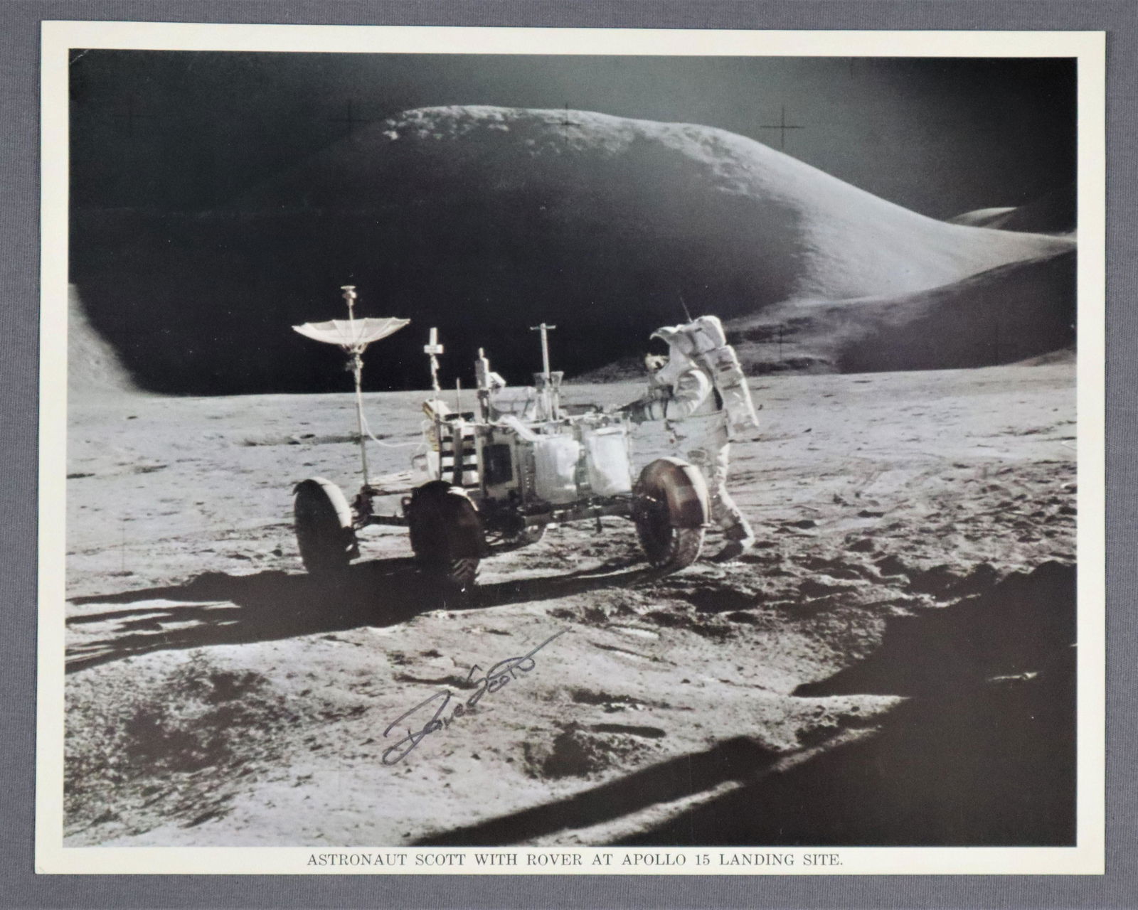 David Scott with Rover Apollo 15 Signed Lithograph: A vintage NASA issued lithograph showing Dave Scott on the Lunar Surface with the Rover. It is hand signed by him in black sharpie marker. This is in very good condition. It measures 8" x 10".