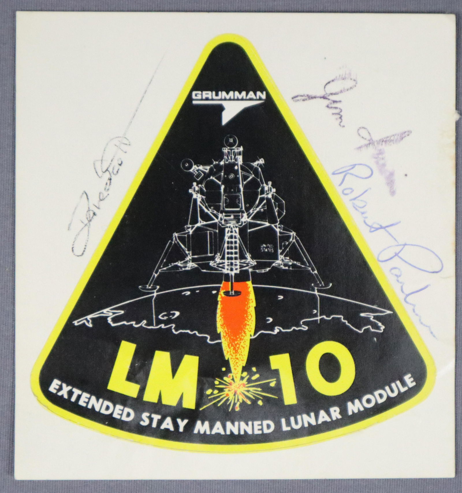 Apollo 15 Signed Grumman LM-10 Decal: A Grumman LM-10 Decal from the personal collection of Grumman Test Astronaut Glennon Kingsley. This has been hand signed by Apollo 15 Mission Commander and 7th Man to Walk on the Moon David Scott alon