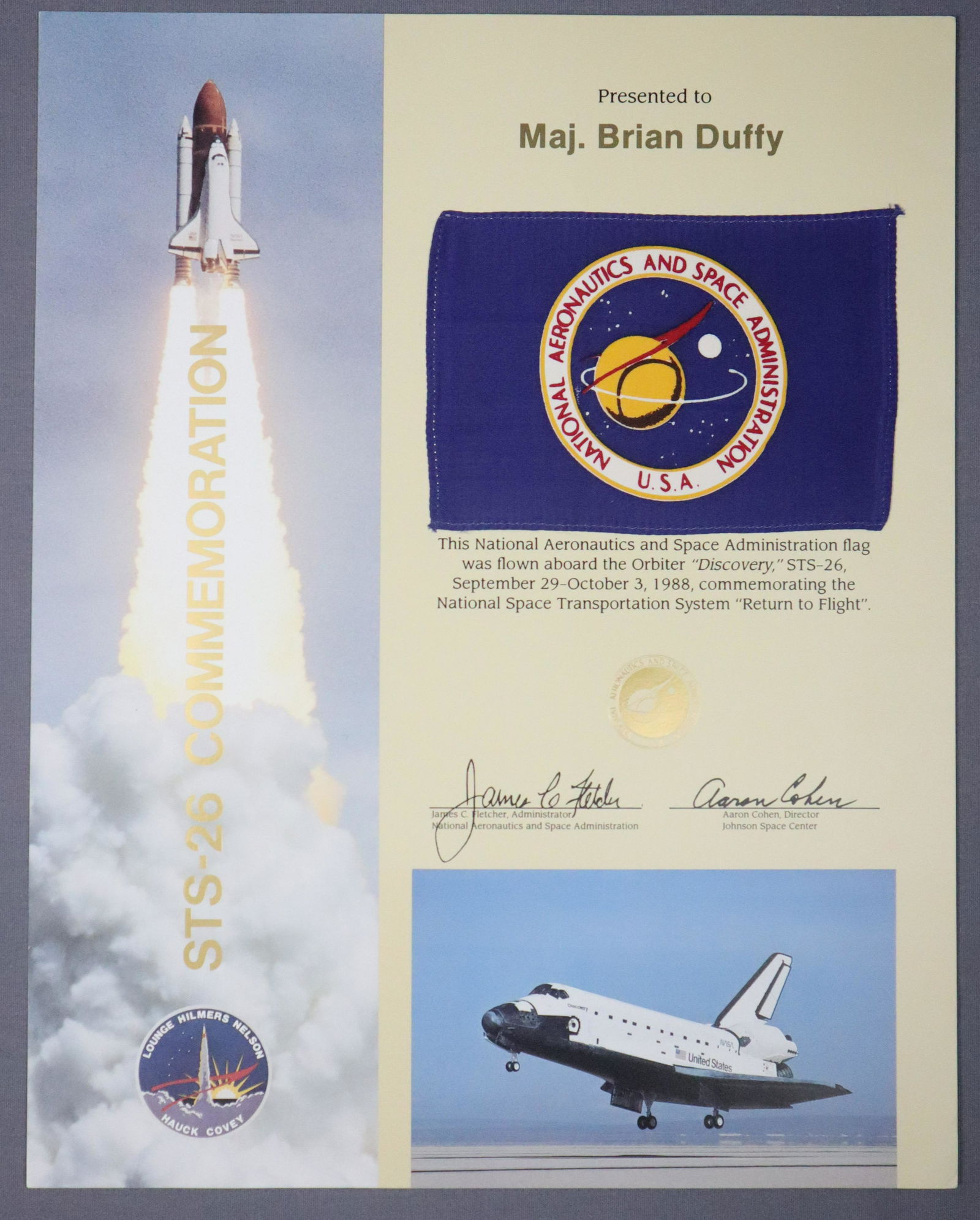 Astronaut Brian Duff's Flown STS-26 Award: This Award was given to Astronaut and Shuttle Commander Brian Duffy. This STS-26 Return to flight award has a 4” x 6” silk NASA Flag that was flown aboard the Space Shuttle Discovery. It c