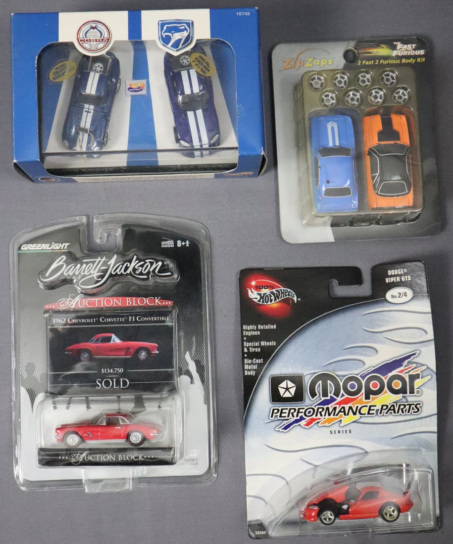 4 - Variety Cars 1/16 Scale Die Cast Metal Cars: This lot consists of four 1/64 scale die cast cars in the original box. Please view pictures for condition of items. There is a Hot Wheels Mopar red Dodge Viper GTS, a red Greenlight Barrett Jackson A