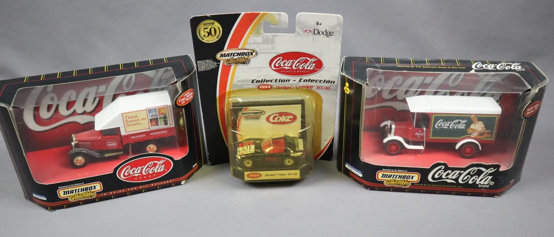 3 - Matchbox Coca Cola Collectibles Die Cast Metal Cars: This lot consists of three die cast cars in the original box. Please view pictures for condition of items. These cars are from the Matchbox Coca Cola Collectibles Series. There is a 1994 Dodge Viper R