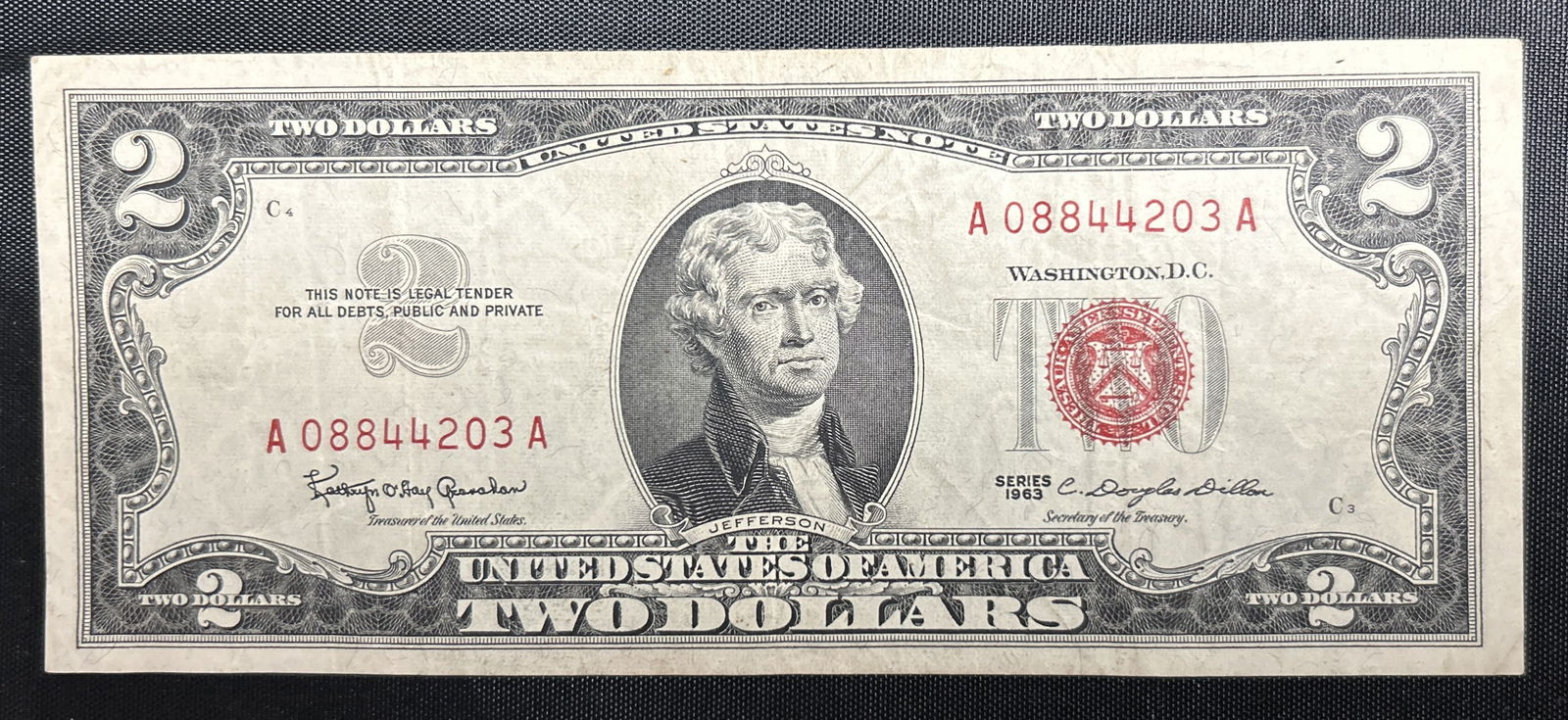 1963 Red Seal Two Dollar Bill: This is a 1963 Series A, Red Seal numbered A08844203A Two Dollar Bill. This bill is in excellent condition with expected handling wear.