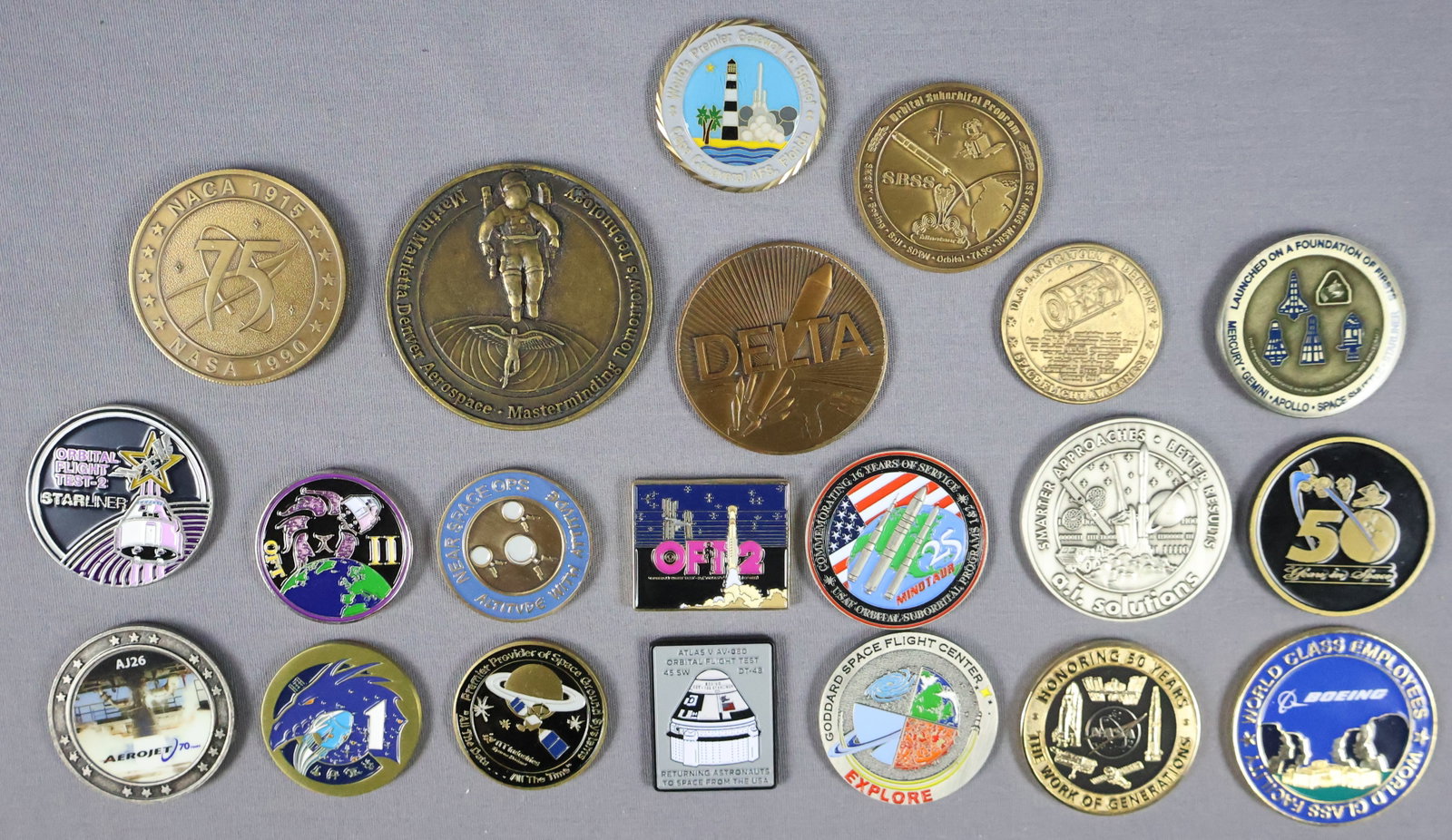21 - NASA Challenge & Mission Coins: This lot includes 21 distinct NASA challenge and mission coins, each featuring a unique design that commemorates various groundbreaking NASA missions and challenges. The coins vary in size and represe