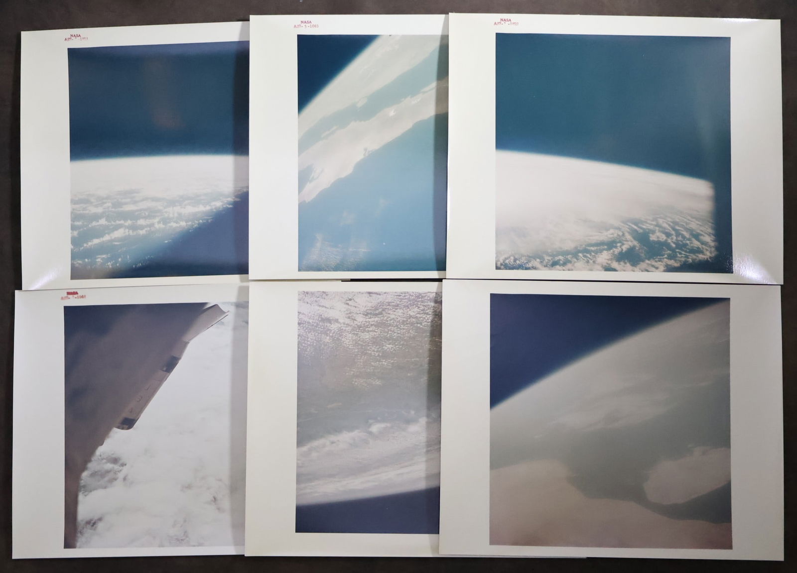 6 - Original NASA Apollo 7 Red Numbered Photographs: A group of six original NASA photographs showing images of Earth captured during the Apollo 7 mission. All the photographs are printed on 'A Kodak Paper' and measure 8" x 10". Four of the six display