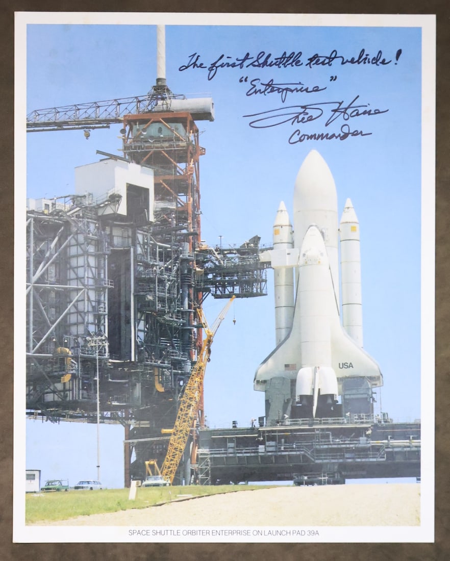 Vintage NASA Fred Haise Signed ALT Lithograph: A vintage NASA issued lithograph showing the Space Shuttle Enterprise on the Launch Pad, the first Shuttle Test Vehicle. The lithograph has been hand signed by Astronaut Fred Haise with "The first