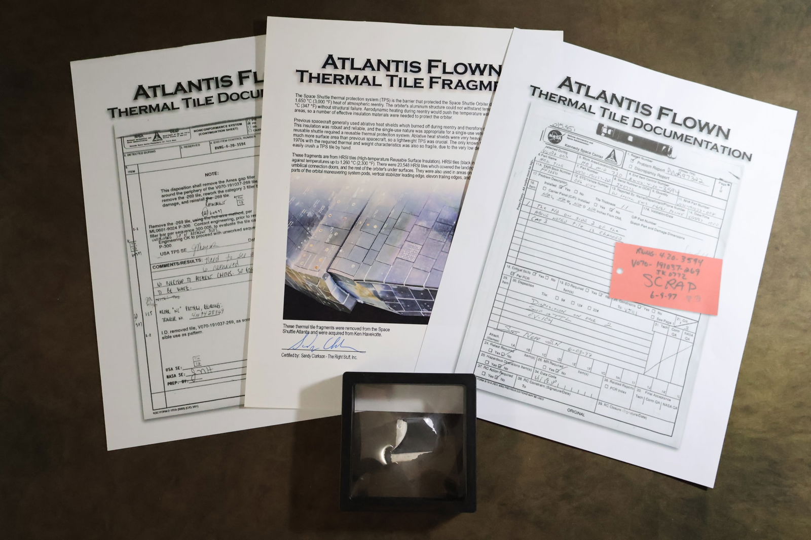 Flown HRSI Tile Fragment from Atlantis with COA: A nice display piece of Space Shuttle Thermal Protection Tile. The Thermal Protection Tiles protected the Space Shuttle Orbiter during the searing heat of atmospheric reentry. This fragment is from a